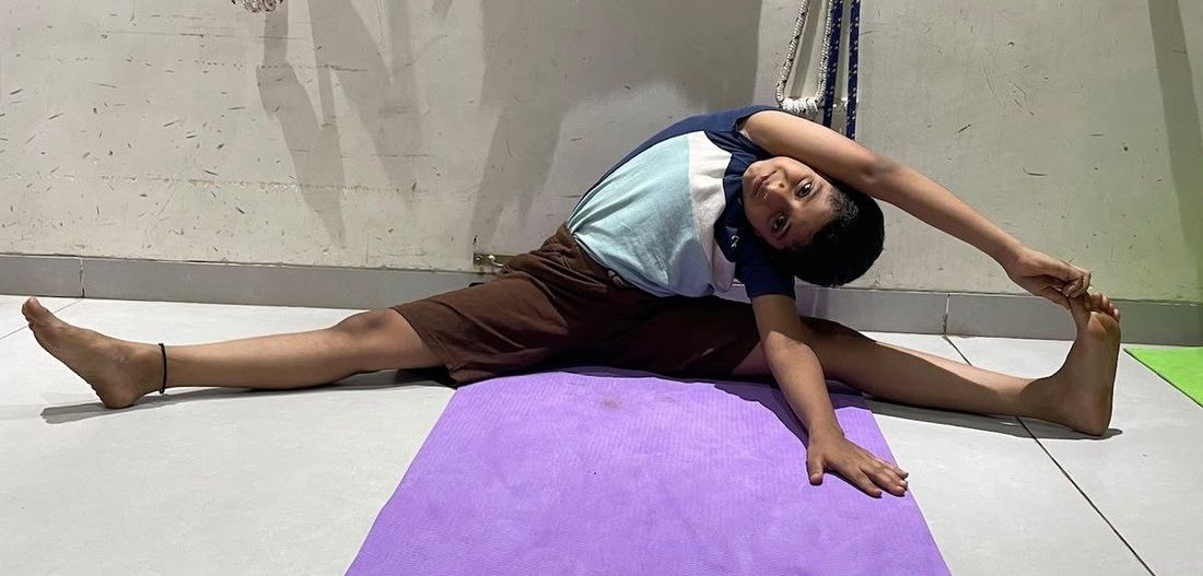 Kids yoga student practicing a side stretch