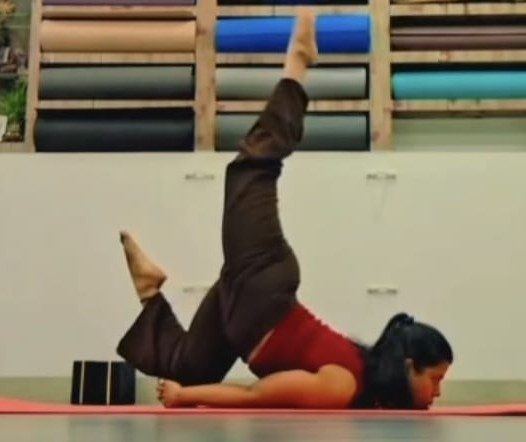 Prop-supported backbend variation on the floor